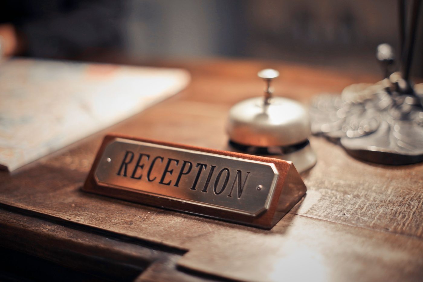 A reception desk sign and a service bell