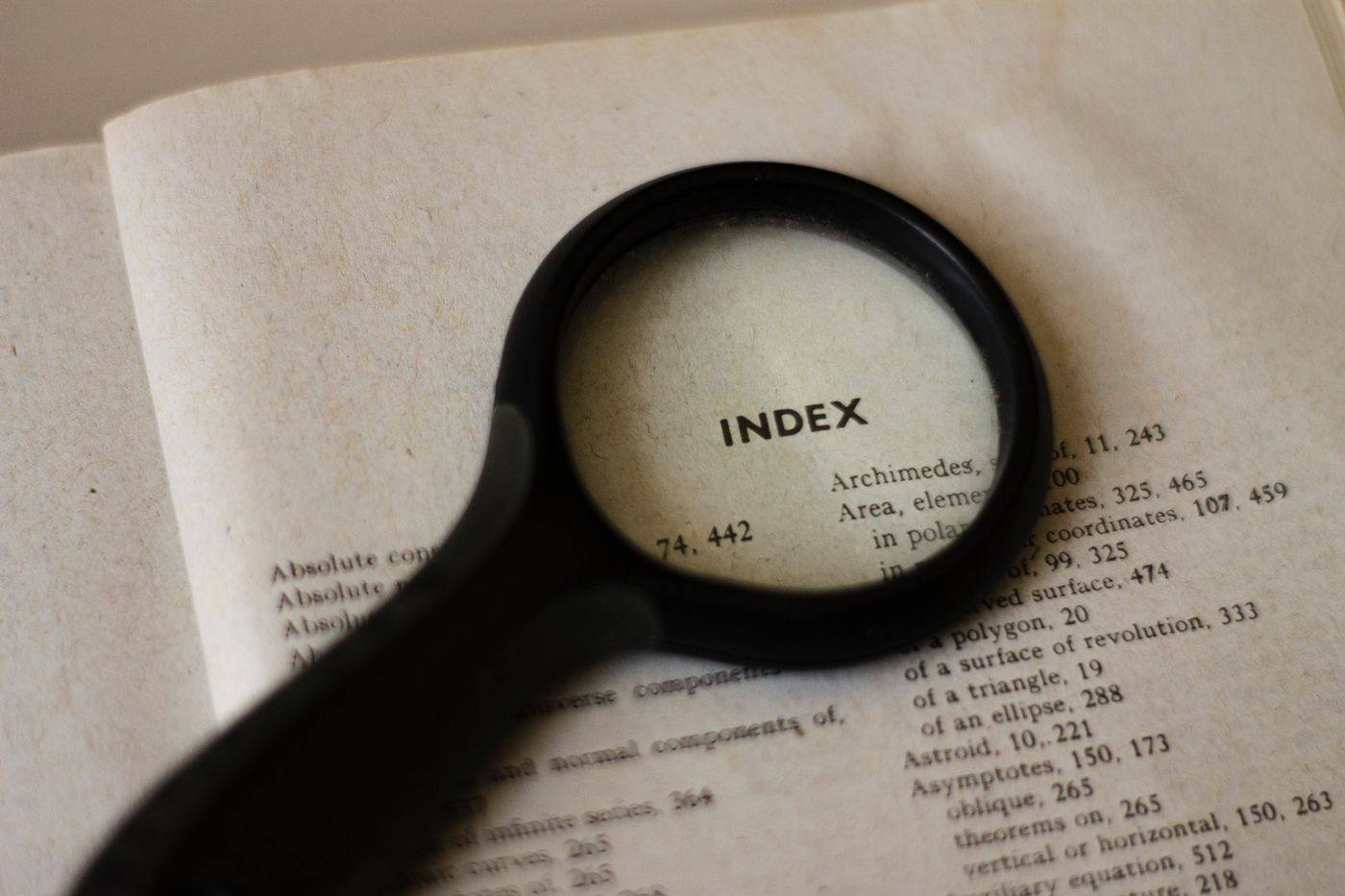 A magnifying glass on a book index