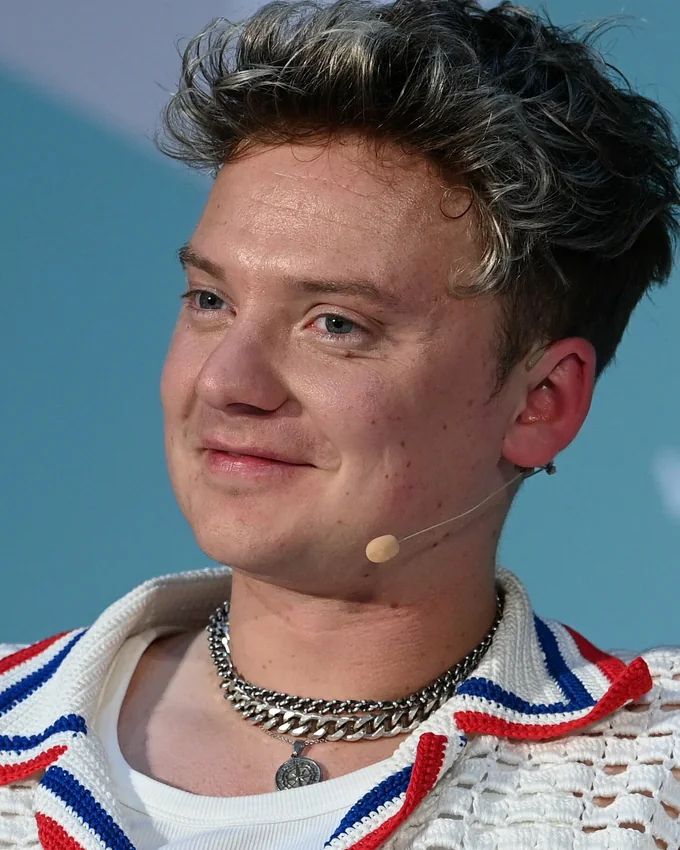 Conor Maynard smiling on stage at Web Summit in 2022